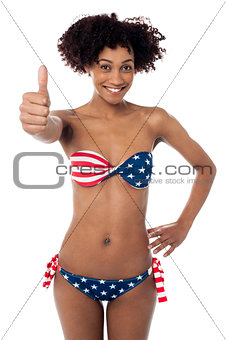 United States flag bikini model gesturing thumbs up