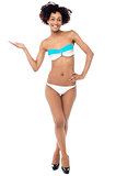 Glamorous woman in swimwear presenting copy space