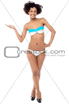 Glamorous woman in swimwear presenting copy space