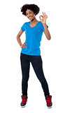 Pretty female model gesturing perfect sign