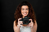 Cheerful woman holding newly launched camera