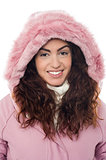 Permed hair woman wearing pink hood winter jacket