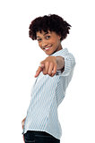 Curly haired casual woman pointing towards you
