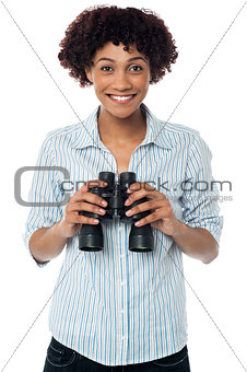 Smiling afro american woman holding binocular