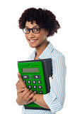 Young businesswoman with calculator and file