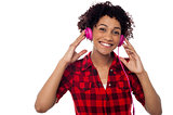 Smiling woman with pink headphones on