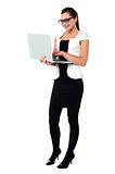 Female secretary using laptop