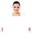 Smiling woman holding blank white ad board