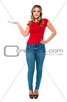 Young girl in trendy wear presenting something