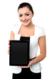 Pretty young girl showcasing a tablet device