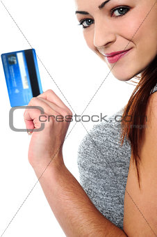 Fashionable young girl holding up a credit card