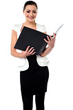 Female secretary reviewing companys file