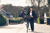 Businesswoman standing on the Street with bike