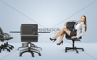 Busineswoman sitting on chair relaxing and looking at camera