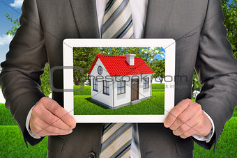 Estate agent showing photo with house on tablet screen