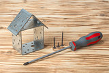 screwdriver house on wooden background