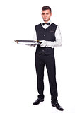Young person in a suit holding an empty tray isolated on white b