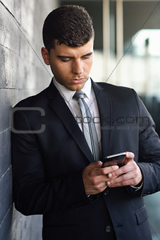 Young businessman on the phone in an office building