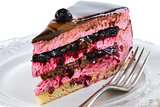 Piece of cake with souffle and jelly berries close up.