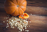 pumpkin and seeds on wood background