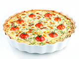 Quiche with cherry tomatoes and herbs on a white plate