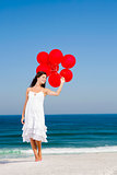 Beautiful girl holding red ballons