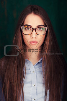 Close-up portrait of beautiful woman in glasses