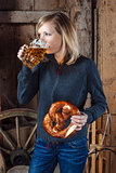 Drinking beer and eating a pretzel