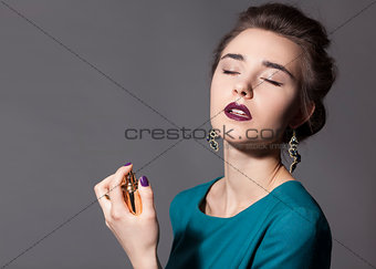Girl holding a bottle of perfume