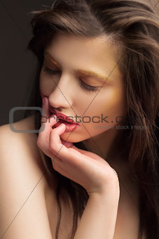 girl with a golden makeup and black background