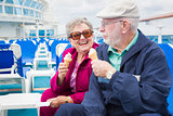Senior Couple Enjoying Ice Cream On Deck Of Cruise Ship