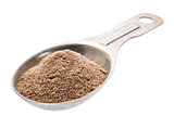 teff flour on measuring spoon