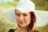 Portrait of cheerful fashionable woman in stylish hat