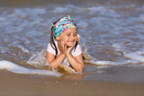 Child resting on the beach