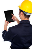 Back pose of worker operating tablet device