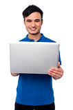 Young guy holding laptop