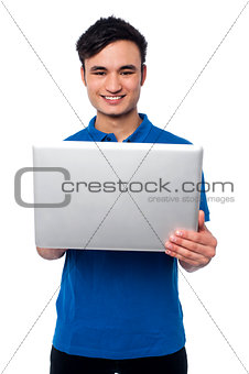Young guy holding laptop