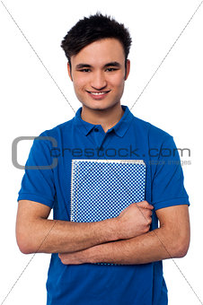 Smiling student embracing his note book