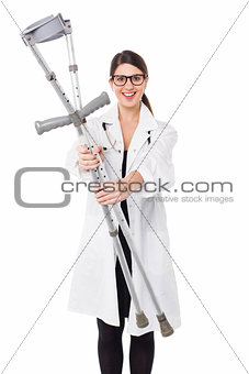 Female doctor displaying a set of crutches