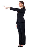 Corporate smiling woman pointing at something
