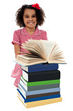 Portrait of pretty schoolgirl reading textbook