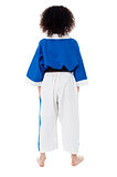 Back pose of a small girl in karate uniform