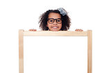 Girl peeping from behind white writing board