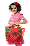 Pretty child carrying math equipment's in basket