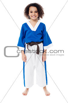 Smiling young girl in karate uniform