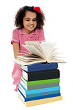 Active kid reading a book and learning