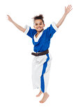 Enthusiastic young girl kid in karate uniform