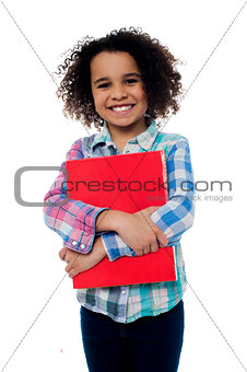 Smiling schoolgirl holding a book