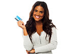 Young woman holding up a credit card