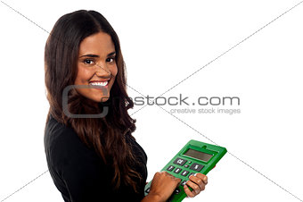 Businesswoman operating big green calculator